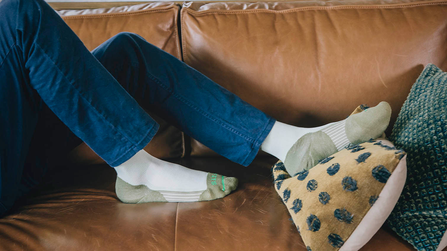 Woman on couch wearing FITS socks