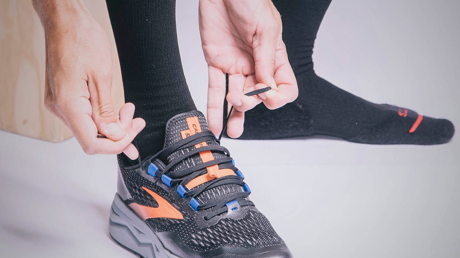 Man wearing FITS Socks tying shoes