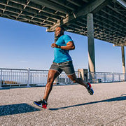 man running under a bridge