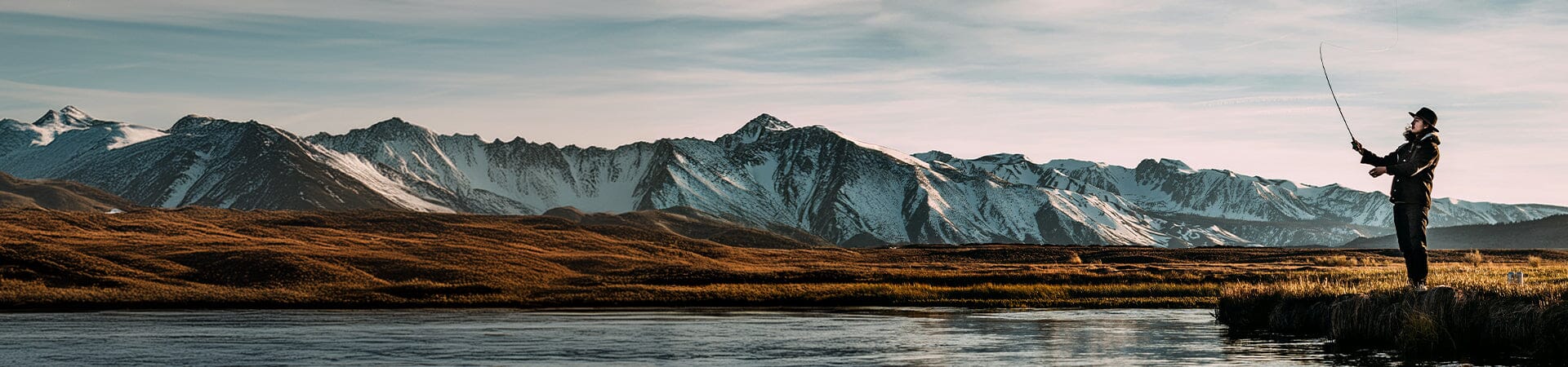 man in field with binoculars 