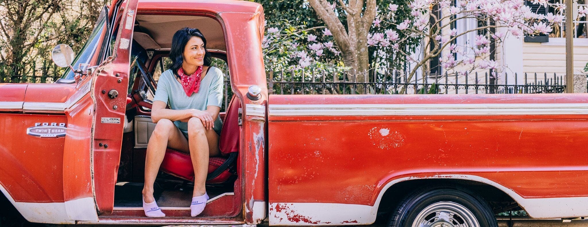 women in front seat of a truck looking out