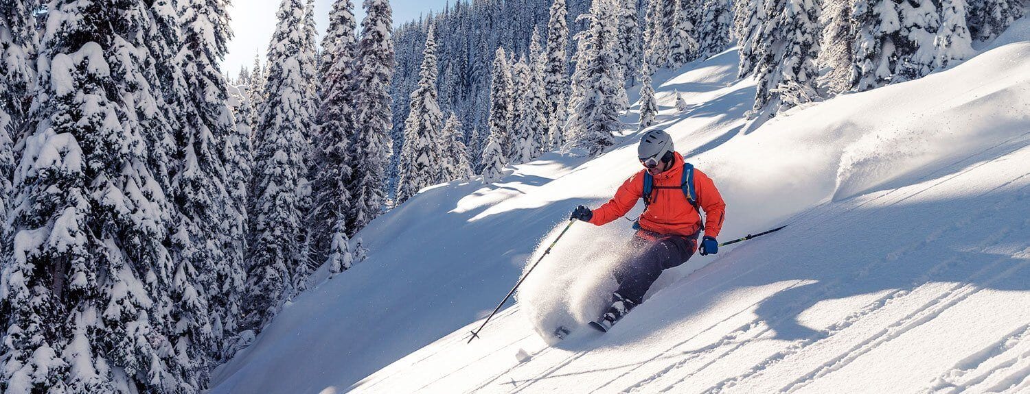 man skiing down mountain